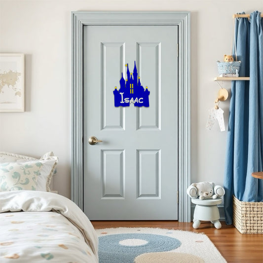 A blue castle-shaped nameplate with "Isaac" written in white, hangs on a light blue door.